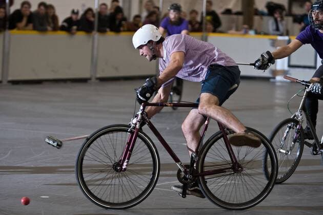 15.01.12 London, England. Player evades his opposing number during the London International Invitational bike polo semi finals match at The Bike Show between Cosmic (purple shirts) of London and Cocorico (pink striped shirts) of France at ExCeL Centre, East London. xDavidxFearn ActionxPlusx  ActionPlus11235027