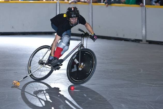 15.01.12 London, England. Player races towards goal during the London International Invitational bike polo semi finals match at The Bike Show between Dead Rappers (black shirts) of London and Hooks (beige shirts) of Paris, France at ExCeL Centre, East London. xDavidxFearn ActionxPlusx  ActionPlus11235032