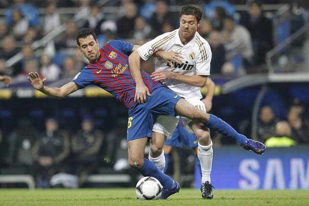 Real Madrid s Xabi Alonso and FC Barcelona s Sergio Busquets during spanish King s Cup on January 18th 2012...Photo: Cesar Cebolla ALFAQUI  (001)