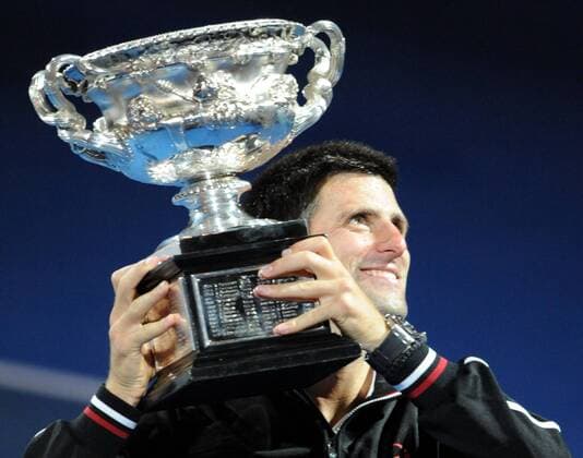(120129) -- MELBOURNE, Jan. 29, 2012 (Xinhua) -- Novak Djokovic of Serbia poses with the trophy during the awarding ceremony for the men s singles final at 2012 Australian Open tennis tournament in Melbourne, Australia, on Jan. 29, 2012. (Xinhua Guo Yong) (hy) AUSTRALIA-MELBOURNE-TENNIS-MEN S-FINAL 