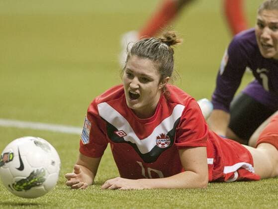 USA s goalkeeper Hope Solo and Canada s Christina Julien (front) watch a loose ball miss an open net during the first half of match 15 of CONCACAF women s Olympic qualifying finals against Canada at BC Place in Vancouver, British Columbia, January 29, 2012. USA beat Canada 4-0.  VAP2012012924