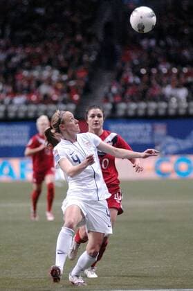 Becky Sauerbrunn (front) of US fights for the ball during the final against Canada at 2012 CONCACAF Women s Olympic Qualifying Soccer Tournament at BC Place in Vancouver, Canada, Jan. 29, 2012. US defeated Canada 4-0 and captured the CONCACAF trophy. Both teams qualified to go to 2012 Summer Olympic Games in London. (Xinhua Sergei Bachlakov) CANADA-VANCOUVER-CONCACAF-WOMEN S OLYMPIC QUALIFYING-FINAL 