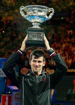 Novak Djokovic of Serbia poses with the trophy during the awarding cerermony for the men s singles final with Rafael Nadal of Spain at 2012 Australian Open tennis tournament in Melbourne, Australia, on Jan. 29, 2012. Djokovic won the champion by defeating Nadal 3-2. (Xinhua Bai Xue) (hy) AUSTRALIA-MELBOURNE-TENNIS-MEN S-FINAL 