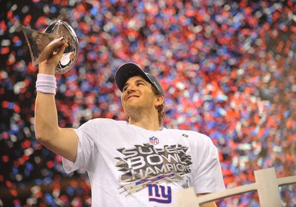 New York Giants quarterback and Super Bowl XLVI MVP Eli Manning celebrates on the podium at Super Bowl XLVI at Lucas Oil Stadium on February 5, 2012 in Indianapolis.  SBP20120205363