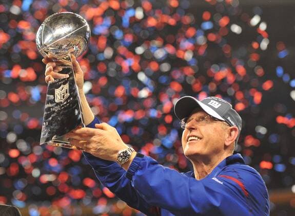 New York Giants head coach Tom Coughlin holds trophy aloft at Super Bowl XLVI at Lucas Oil Stadium on February 5, 2012 in Indianapolis.  SBP20120205366