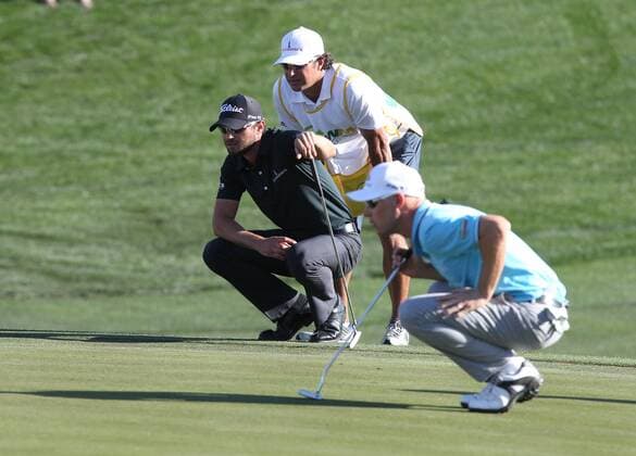Feb. 5, 2012 - Phoenix, Arizona, U.S. - 5 February 2012: Kyle Stanley and Ben Crane check the lines as they prepare to putt on the 18th hole of the Waste Management Phoenix Open. - ZUMAx81