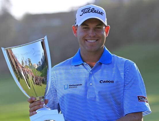 Bill Haas holds the championship trophy after winning a three-way playoff at the second extra hole at the Northern Trust Open at the Riviera Country Club in the Pacific Palisades area of Los Angeles on February 19, 2012. Haas rolled in a 45-foot birdie putt and finished the tournament at 7-under.  LAP201202197013