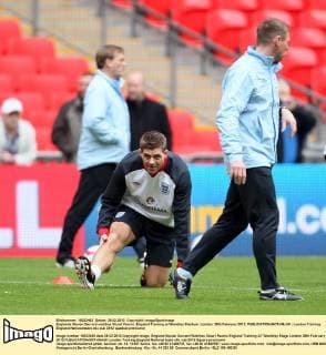 Englands Steven Gerrard watches Stuart Pearce..England Training at Wembley Stadium, London. 28th February 2012. EDITORIAL USE ONLY. No use with unauthorised audio, video, data, fixture lists, club league logos or live services. Online in-match use limited to 120 images, no video emulation. No use in betting, games or single club league player publications.