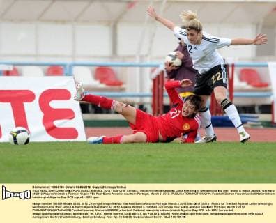 VILA REAL SANTO ANTONIO(PORTUGAL), March 2, 2012 - Gao Qi of China (L) fights for the ball against Luisa Wensing of Germany during their group A match against Germany at 2012 Algarve Women s Football Cup in Vila Real Santo Antonio, southern Portugal, March 2, 2012. 