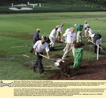 April 4, 2012 - Augusta, GA, USA - Groundskeepers hurry to clean up debris near Amen Corner at Augusta National Golf Club in Augusta, Georgia, Wednesday, April 4, 2012. An overnight storm dumped 1.4 inches of rain on the area, forcing the significant clean-up project on the final practice day prior to Thursday s start of The Masters. Practice for The Masters - ZUMAm67