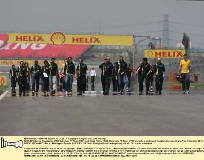 12.04.2012 Heikki Kovalainen (FIN) Caterham F1 Team CT01 and Vitaly Petrov (RUS) Caterham F1 Team CT01 are talke a looking of the track Chinese Grand Prix, Shanghai 2012 