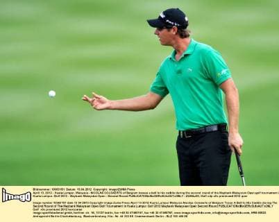 April 13, 2012 - Kuala Lumpur, Malaysia - NICOLAS COLSAERTS of Belgium tosses a ball to his caddie during the second round of the Maybank Malaysian Open golf tournament in Kuala Lumpur. Golf 2012 - Maybank Malaysian Open - Second Round - ZUMAz93