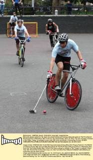 Bike polo players pedal for the reach of a street hockey ball during a bike polo game at The Pit at Sara D. Roosevelt Park in Manhattan, New York City, the United States, April 15, 2012. The was invented in Ireland in the 1890s. Today, it is played in more than 300 ciites worldwide. (Xinhua Zhai Xi) (jyc) US-NEW YORK-BIKE POLO 