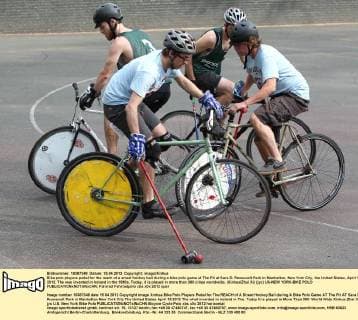 Bike polo players pedal for the reach of a street hockey ball during a bike polo game at The Pit at Sara D. Roosevelt Park in Manhattan, New York City, the United States, April 15, 2012. The was invented in Ireland in the 1890s. Today, it is played in more than 300 ciites worldwide. (Xinhua Zhai Xi) (jyc) US-NEW YORK-BIKE POLO 