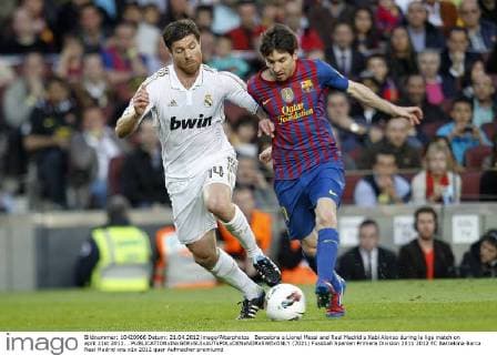 Barcelona s Lionel Messi and Real Madrid s Xabi Alonso during la liga match on april 21st 2012...  (7021)