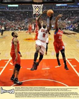 Chicago Bulls forward Luol Deng (C) goes up for a shot as Philadelphia 76ers guard Jrue Holiday (R) and forward Andre Iguodala defend during the first quarter of game 5 of the first round of the Eastern Conference Playoffs at the United Center on May 1, 2012 in Chicago.  CHI2012050807