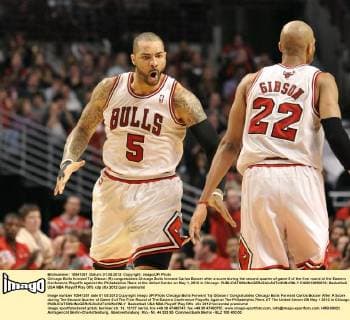 Chicago Bulls forward Taj Gibson (R) congratulates Chicago Bulls forward Carlos Boozer after a score during the second quarter of game 5 of the first round of the Eastern Conference Playoffs against the Philadelphia 76ers at the United Center on May 1, 2012 in Chicago.  CHI2012050812