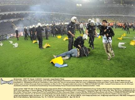 Turkey super league playoff championship group football match between Fenerbahce and Galatasaray at Sukru Saracoglu Stadium in Istanbul on May 12, 2012. Match Scored: Fenerbahce 0 - Galatasaray 0 Pictured: Fenerbahce s fans clash with Turkish riot policemen after the victory of Galatasaray at the end of their Turkish Super League playoff final football match at Sukru Saracoglu Stadium in Istanbul, on May 12, 2012. The game ended with a draw 0-0. 