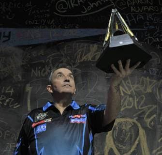 16.05.2012 London, England. Phil Taylor poses with the trophy. The McCoy s 2012 PDC Premier League Darts Media Launch Day from The O2 Arena, London. xStephenxBartholomewx  ActionPlus11276221