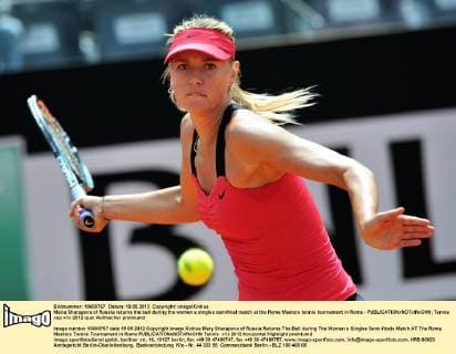 Maria Sharapova of Russia returns the ball during the women s singles semifinal match at the Rome Masters tennis tournament in Rome - 