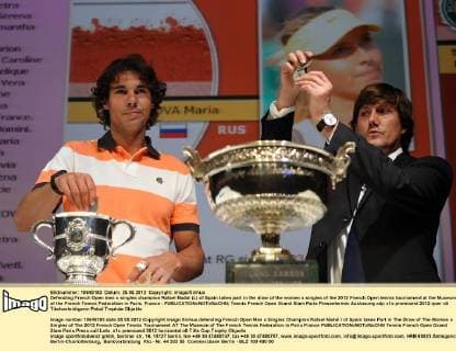 Defending French Open men s singles champion Rafael Nadal (L) of Spain takes part in the draw of the women s singles of the 2012 French Open tennis tournament at the Museum of the French Tennis Federation in Paris, France - 