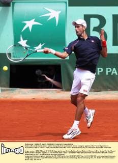 Serbia s Novak Djokovic returns a shot during the 2nd round match of men s singles against at the French Open tennis tournament in Paris, France - 