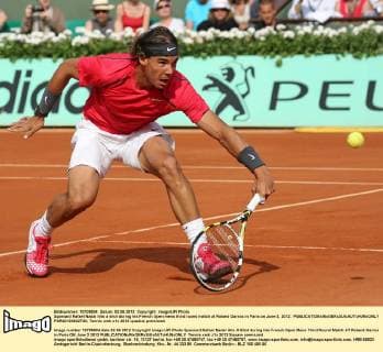 Spaniard Rafael Nadal hits a shot during his French Open mens third round match at Roland Garros in Paris on June 2, 2012.  PAR20120602736