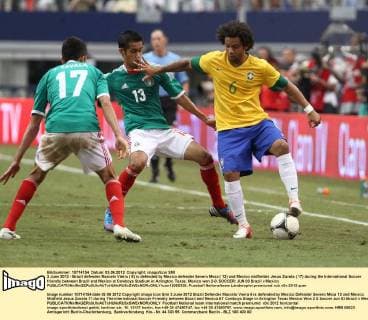 3 June 2012 - Brazil defender Marcelo Vieira ( 6) is defended by Mexico defender Severo Meza ( 13) and Mexico midfielder Jesus Zavala ( 17) during the International Soccer friendly between Brazil and Mexico at Cowboys Stadium in Arlington, Texas. Mexico won 2-0. SOCCER: JUN 03 Brazil v Mexico Icon12060320 EDITORIAL USE ONLY