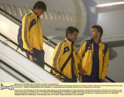Players of the Ukrainian national football team Denys Harmash, Ruslan Rotan and Andriy Yarmolenko (L to R) go down airstairs in the International Airport Biryspil, Kyiv region, June 6, 2012. - 