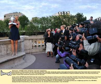 Maria Sharapova of Russia poses with her trophy near the Eiffel Tower after winning her women s final against Sara Errani of Italy at the French Open tennis tournament at the Roland Garros stadium in Paris June 9, 2012. (Xinhua Wang Qingqin) FRANCE-PARIS-FRENCH OPEN-SHARAPOVA 