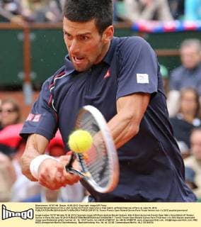 Serbian Novak Djokovic hits a shot during his French Open men s final match at Roland Garros in Paris on June 10, 2012.  PAR20120610716