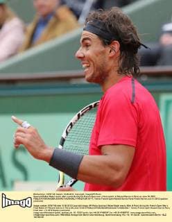 Spaniard Rafael Nadal reacts after a point during his French Open men s final match at Roland Garros in Paris on June 10, 2012.  PAR20120610717