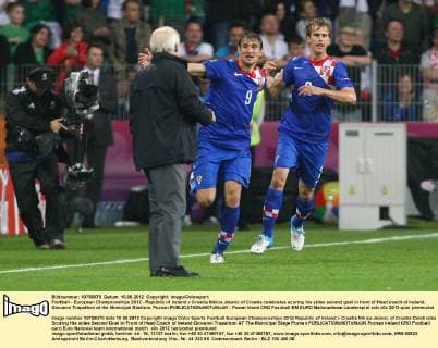 Football - European Championships 2012 - Republic of Ireland v Croatia Nikica Jelavic of Croatia celebrates scoring his sides second goal in front of Head coach of Ireland, Giovanni Trapattoni at the Municipal Stadium, Poznan 