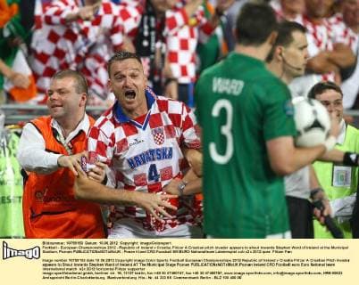 Football - European Championships 2012 - Republic of Ireland v Croatia, Flitzer A Croatian pitch invader appears to shout towards Stephen Ward of Ireland at the Municipal Stadium, Poznan 