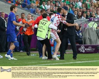 Football - European Championships 2012 - Republic of Ireland v Croatia, Flitzer A Croatian fan invades the pitch and appears to kiss Head coach of Croatia, Slaven Bilic at the Municipal Stadium, Poznan 