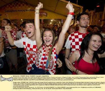Croatian soccer fans cheer while watching the televised match between Croatia and Ireland, in Zagreb, Croatia, June 10, 2012. Thousands of fans watched the Group C match between Croatia and Ireland on a big screen at Zagreb s central square on Sunday. Croatia won 3-1. (Xinhua Miso Lisanin) CROATIA-ZAGREB-EURO 2012-FANS 