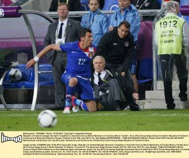 Republic of Ireland manager Giovanni Trapattoni is knocked over by Mario Mandzukic of Croatia, Marco Tardelli ..Euro 2012 Group Stage (Group C) match, Republic Of Ireland v Croatia at the Municipal Stadium, Poznan, Poland on the 10th June 2012. Pic Jake Badger SPORTIMAGE... EDITORIAL USE ONLY. No use with unauthorised audio, video, data, fixture lists, club league logos or live services. Online in-match use limited to 120 images, no video emulation. No use in betting, games or single club league player publications.
