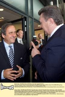 Ukrainian President Viktor Yanukovych (R) talks with UEFA President Michel Platini ahead of the EURO 2012 opening ceremony in Warsaw, Poland, June 8, 2012. Photo by Mykhailo Markiv POOL - 