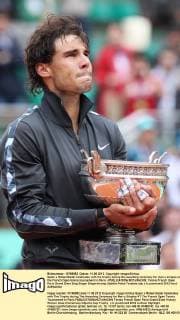 Spain s Rafael Nadal celebrates with the trophy during the awarding ceremony for men s singles at the French Open tennis tournament in Paris - 