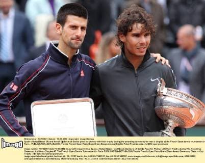 Spain s Rafael Nadal (R) and Novak Djokovic of Serbia pose for photos with their trophy during the awarding ceremony for men s singles at the French Open tennis tournament in Paris - 