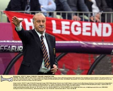 GDANSK, POLAND. JUNE 10, 2012. Spain s coach Vicente del Bosque watches a Euro 2012 Group Stage match between Italy and Spain at Arena Gdansk. The game ended in a 1-1 draw. The banner behind reads: The Legend (Returns).  RE100BA5