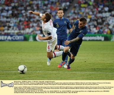 Football - UEFA Euro 2012 - France vs. England England s Steven Gerrard goes down under the challenge of Mathieu Debuchy and Yahan Cabaye of France at the Donbass Arena, Donetsk, Ukraine 