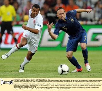 ITAR-TASS: DONETSK, UKRAINE. JUNE 11, 2012. Englandâ€™s Ashley Cole (L) and Franceâ€™s Franck Ribery fight for the ball in their Euro 2012 Group D football match at Donbass Arena. The game ended in a 1-1 draw.  RE100CED