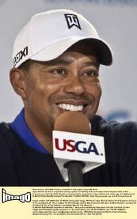 Tiger Woods smiles at a question during a press availability at the U.S. Open at the Olympic Club in San Francisco on June 12, 2012. Woods is coming off his second win of the season two weeks ago at the Memoria.l  SXP2012061202