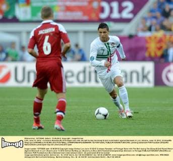 LVIV, June 13, 2012 -- Cristiano Ronaldo (R) of Portugal runs with the ball during the Group B 2nd round match against Denmark in Lviv, Ukraine, June 13, 2012. (Xinhua Ma Ning) (jyc) UKRAINE-LVIV-EURO 2012 FOOTBALL CHAMPIONSHIPS-DENMARK VS PORTUGAL 