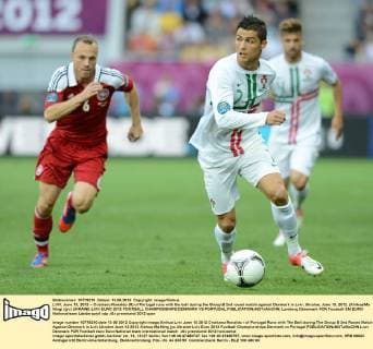 LVIV, June 13, 2012 -- Cristiano Ronaldo (R) of Portugal runs with the ball during the Group B 2nd round match against Denmark in Lviv, Ukraine, June 13, 2012. (Xinhua Ma Ning) (jyc) UKRAINE-LVIV-EURO 2012 FOOTBALL CHAMPIONSHIPS-DENMARK VS PORTUGAL 