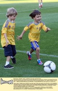 Andriy Shevchenko s son Christian (L) and Tymur Shamanov, the instant face of Ukraine, play football during the Ukrainian national football team s training session held at the Dynamo Stadium, Kyiv, capital of Ukraine, June 13, 2012. - 