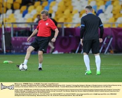 Football - European Championships 2012 Football - European Championships 2012 - England Training Roy Hodgson, Manager of England passes a ball to Wayne Rooney during training at the Olympic Stadium, Kiev, Ukraine 