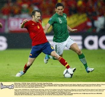 Andres Iniesta of Spain holds off Keith Andrews of Republic of Ireland..Euro 2012 Group Stage (Group C) match, Spain v Republic of Ireland at Arena Gdansk, Gdansk, Poland on the 14th June 2012. Pic Jake Badger SPORTIMAGE... EDITORIAL USE ONLY. No use with unauthorised audio, video, data, fixture lists, club league logos or live services. Online in-match use limited to 120 images, no video emulation. No use in betting, games or single club league player publications.