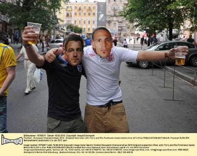 Football - European Championships 2012 - England fans wear John Terry and Rio Ferdinand masks before kick off in Kiev 